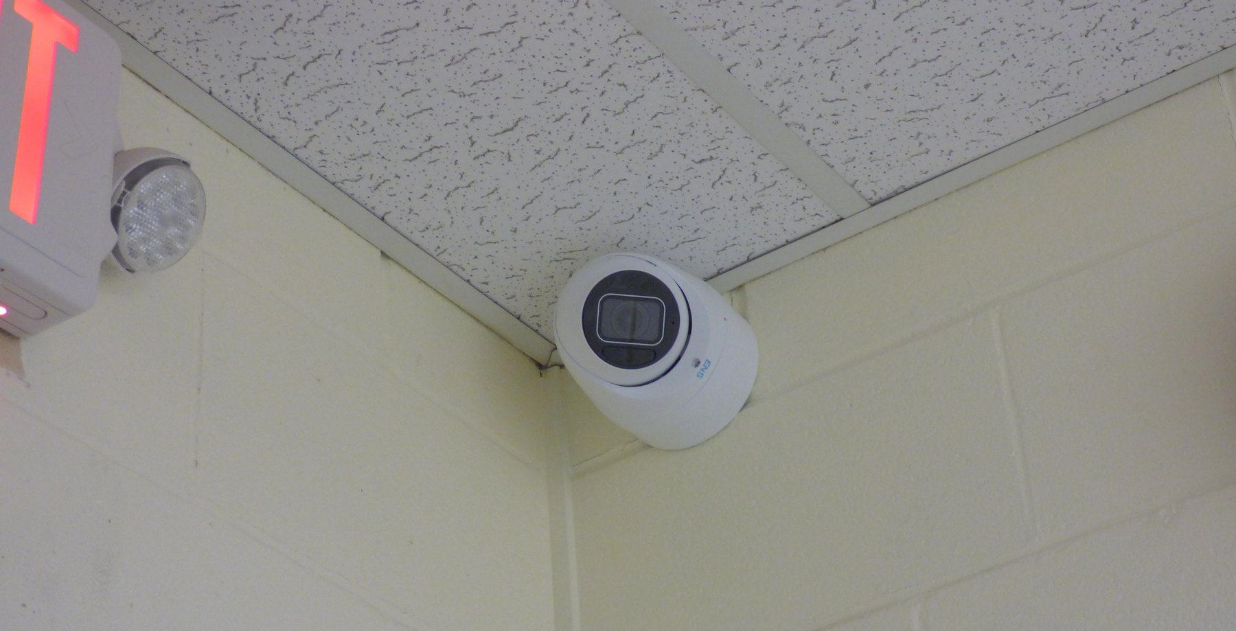 White turret camera in an inside corner