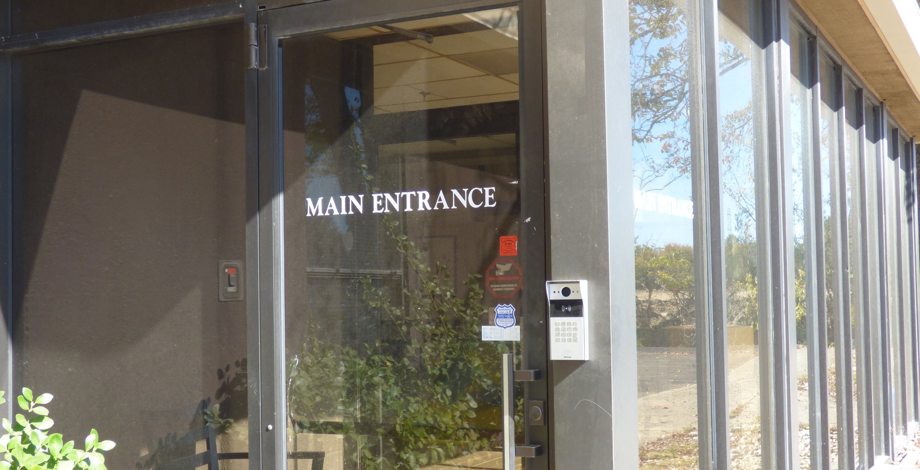 Video door station with a keypad beside the main entrance door