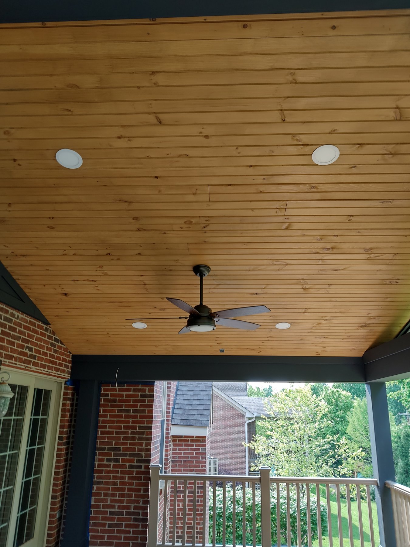 Recessed lights in a wood porch ceiling