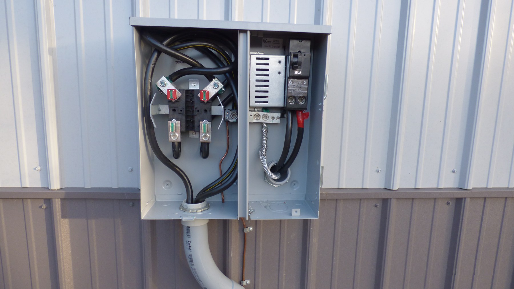 Open meter base with service conductors and a 200-amp breaker